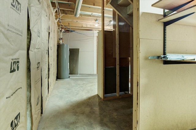 hallway with concrete flooring and water heater