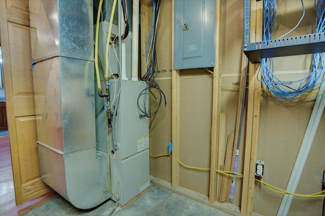 utility room with heating unit and electric panel