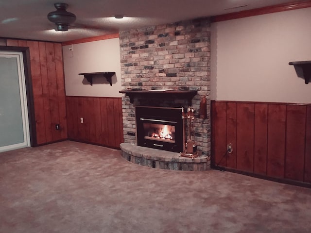 unfurnished living room featuring ornamental molding, a textured ceiling, light carpet, and a brick fireplace