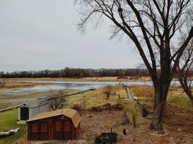 view of yard with a water view and a storage shed