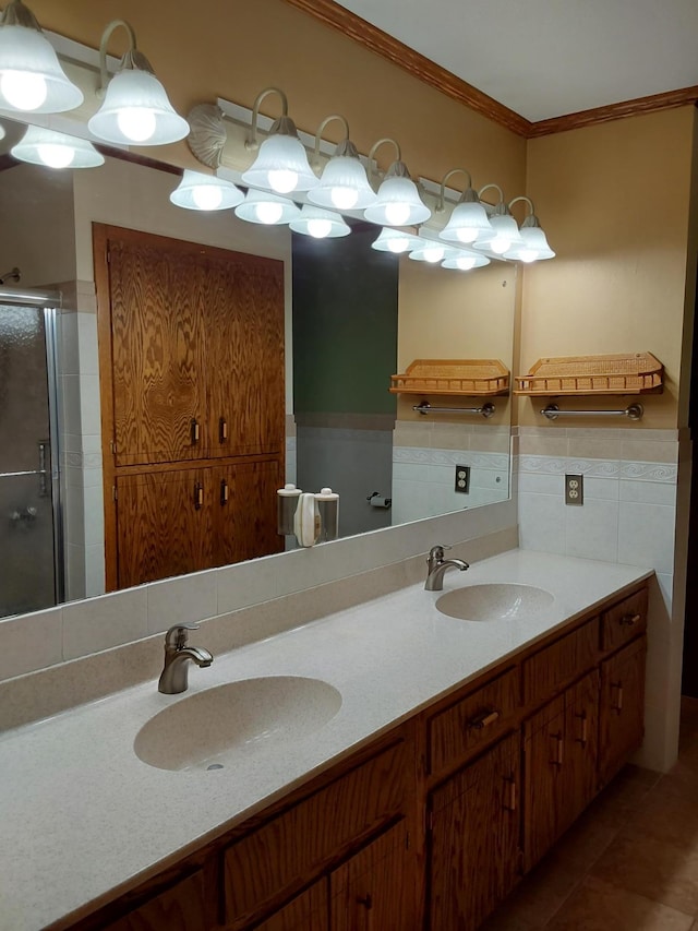 bathroom featuring tile patterned floors, vanity, an enclosed shower, and crown molding