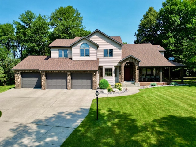 view of front of home featuring covered porch, a front yard, and a garage