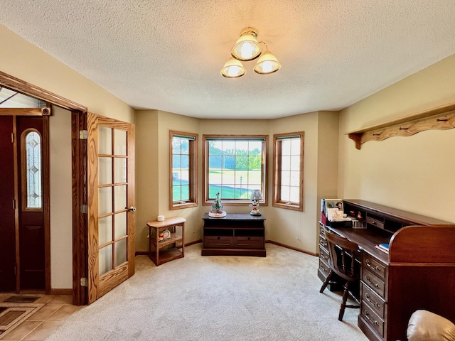 office space with light colored carpet and a textured ceiling