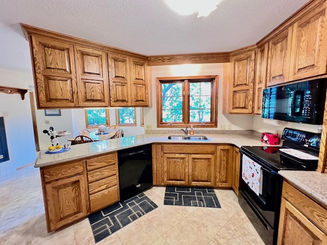 kitchen featuring black appliances, kitchen peninsula, sink, and a textured ceiling