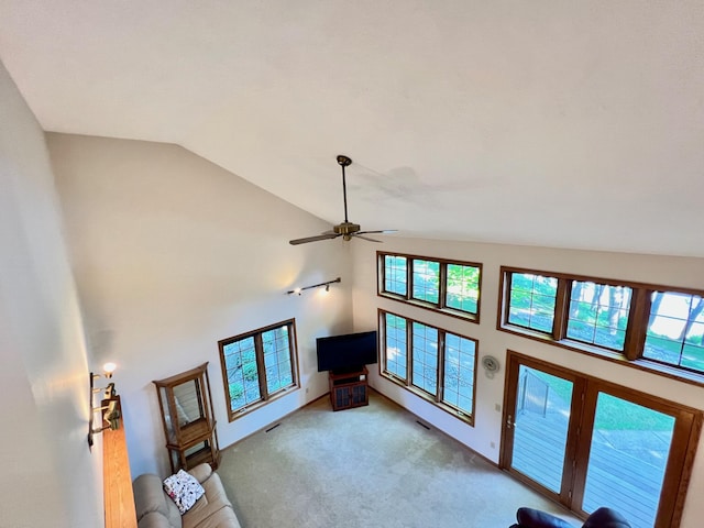 living room featuring ceiling fan, plenty of natural light, carpet, and lofted ceiling