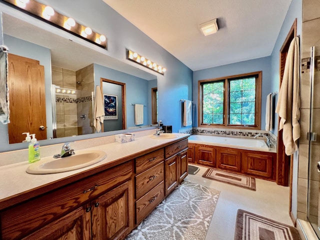 bathroom featuring vanity and shower with separate bathtub