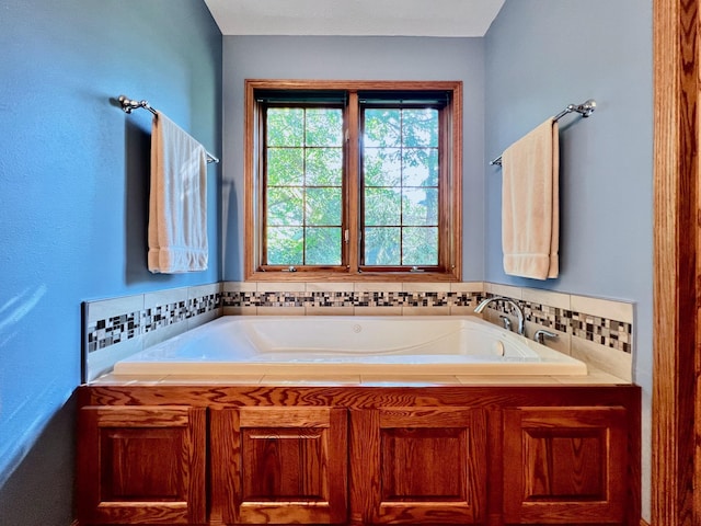 bathroom featuring a tub to relax in and backsplash