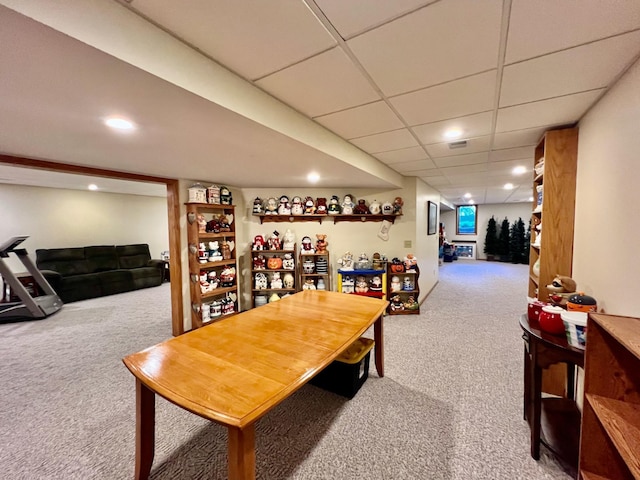 dining area with carpet flooring and a drop ceiling