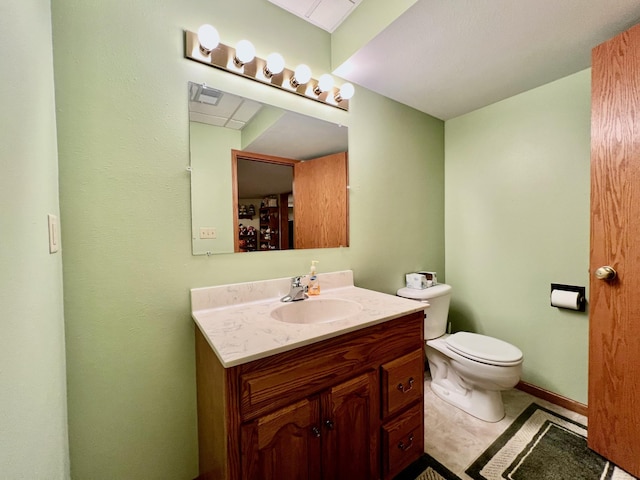 bathroom with tile patterned floors, vanity, and toilet