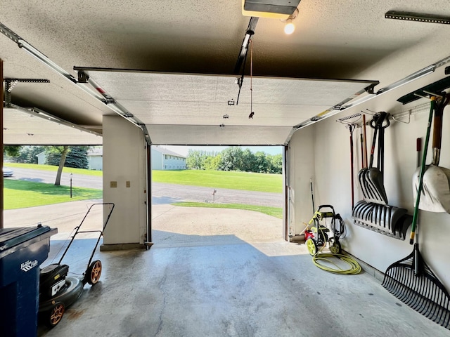 garage with a yard and a garage door opener