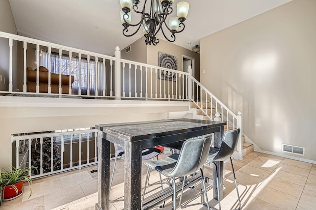 dining space featuring lofted ceiling and a notable chandelier