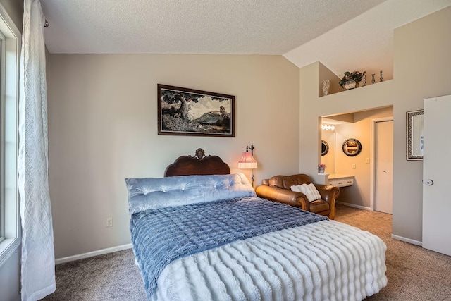 bedroom featuring a textured ceiling, lofted ceiling, and carpet floors