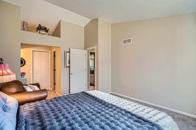 carpeted bedroom with a textured ceiling and high vaulted ceiling