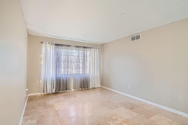 empty room with a textured ceiling