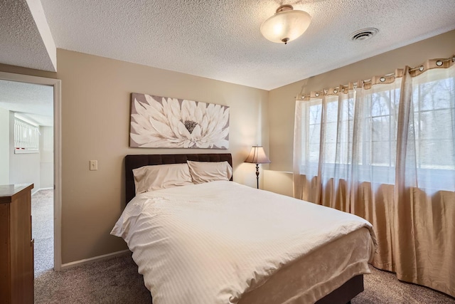 bedroom featuring carpet floors and a textured ceiling