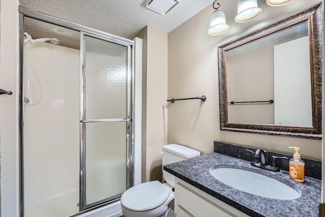 bathroom with vanity, a textured ceiling, toilet, and an enclosed shower