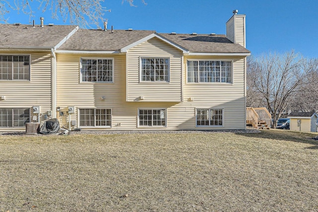 back of house with a lawn