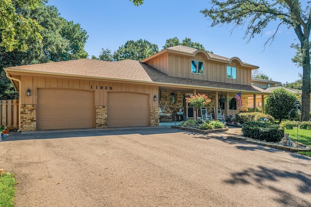 view of front of property featuring covered porch and a garage