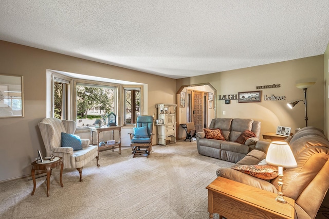 living room featuring light carpet and a textured ceiling