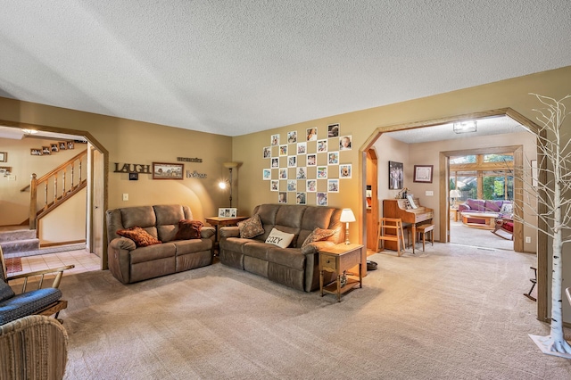 carpeted living room with a textured ceiling