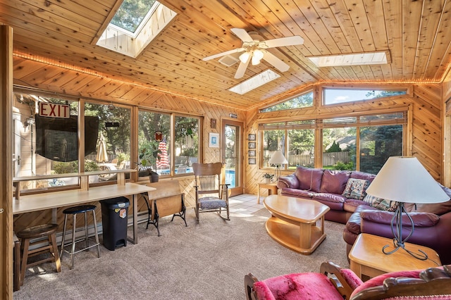 sunroom / solarium featuring vaulted ceiling with skylight, ceiling fan, wood ceiling, and a baseboard heating unit