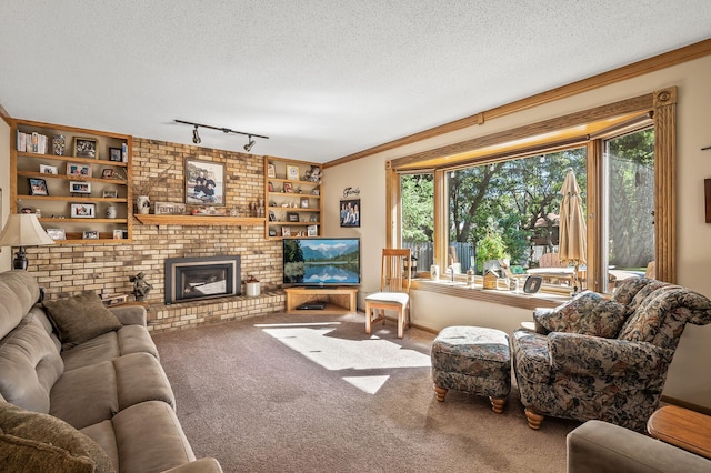 living room featuring carpet, track lighting, a brick fireplace, ornamental molding, and a textured ceiling