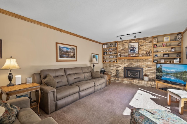 carpeted living room featuring built in features, a textured ceiling, rail lighting, and a brick fireplace