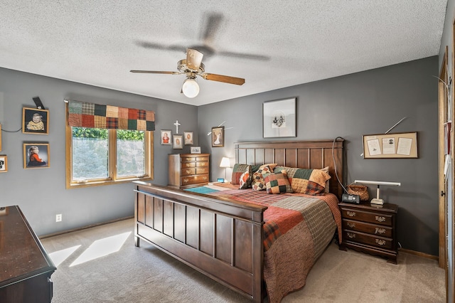 bedroom featuring light carpet, a textured ceiling, and ceiling fan