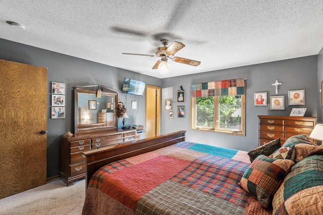 carpeted bedroom with ceiling fan and a textured ceiling