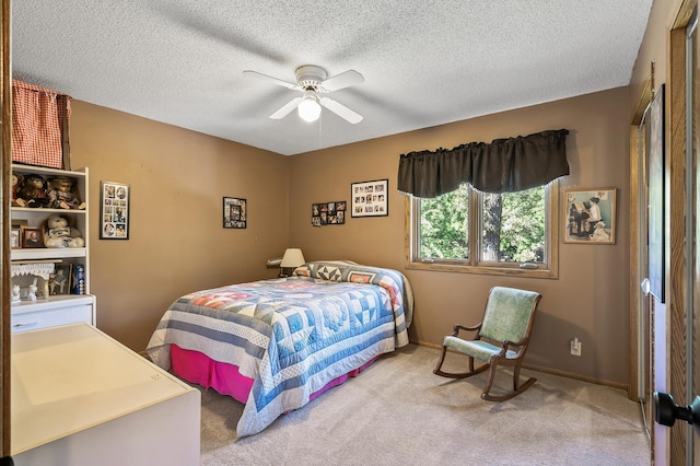 carpeted bedroom with a textured ceiling and ceiling fan