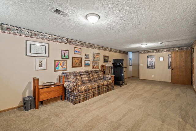 carpeted living room featuring a textured ceiling