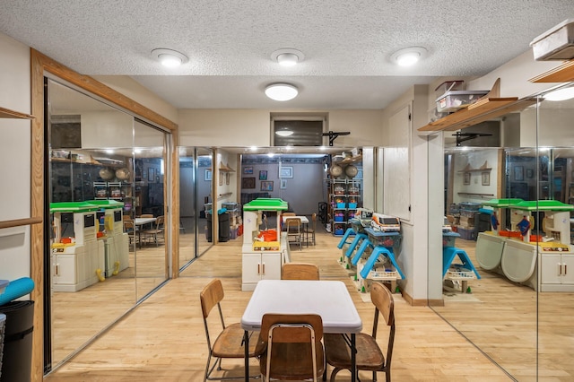 dining area featuring a textured ceiling and light wood-type flooring