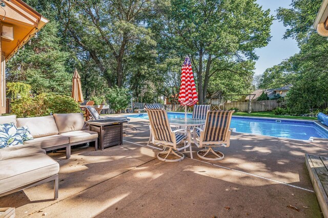 view of pool with outdoor lounge area and a patio