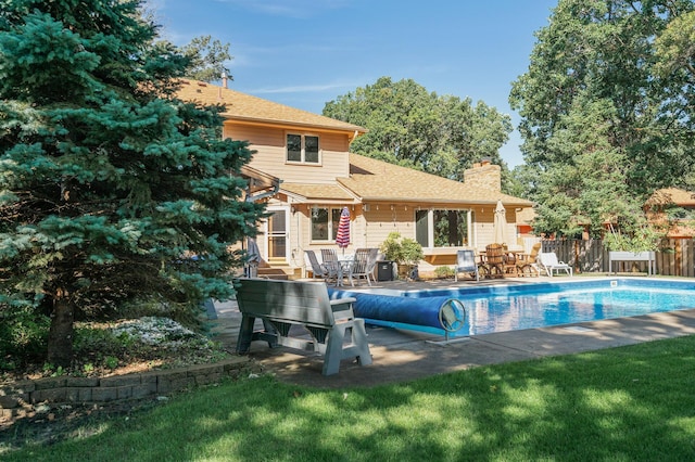 view of pool featuring a yard and a patio