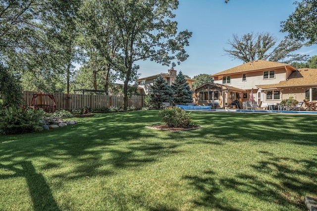 view of yard with a fenced in pool