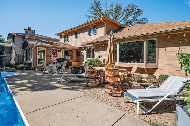 rear view of property featuring a patio area