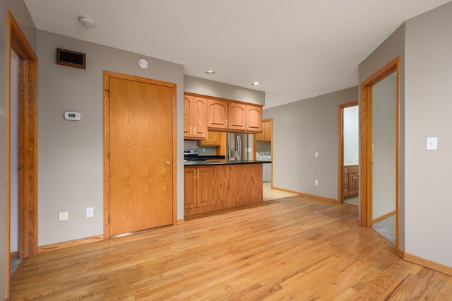 kitchen featuring light wood-type flooring and stainless steel refrigerator with ice dispenser