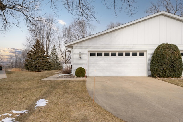 view of side of property with a lawn and driveway
