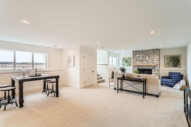 living room featuring a fireplace and light colored carpet