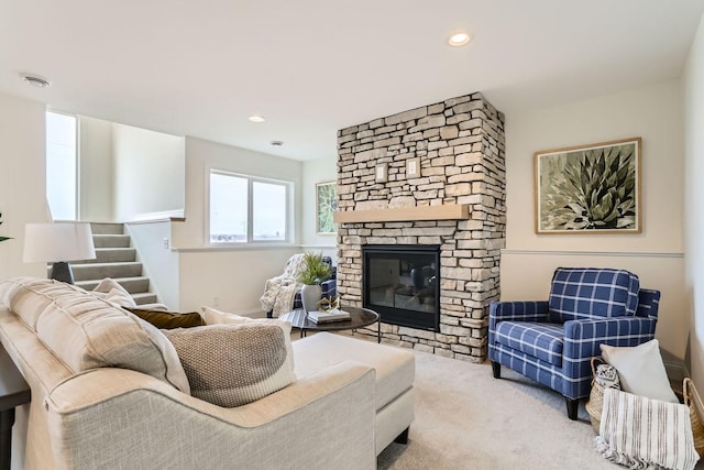 living room featuring a fireplace and light colored carpet