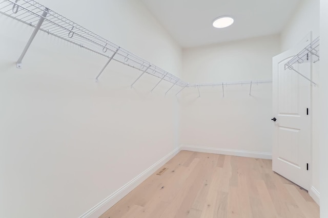 walk in closet featuring light hardwood / wood-style flooring