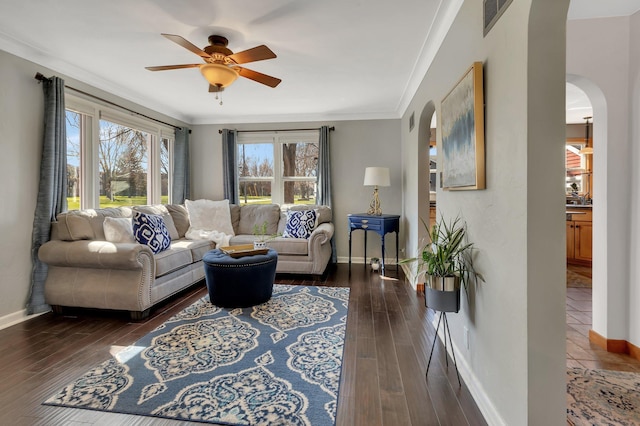 living room with ceiling fan, dark hardwood / wood-style floors, and ornamental molding