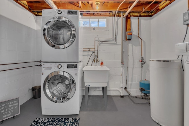 clothes washing area with sink and stacked washer / dryer