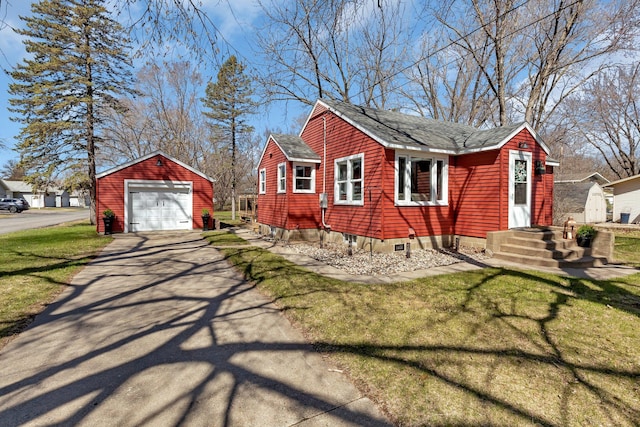 view of side of property with a lawn, a garage, and an outdoor structure