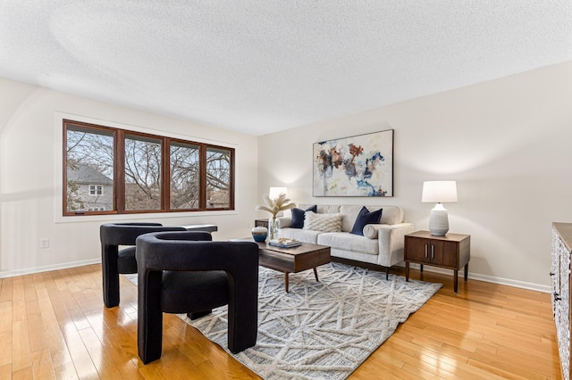 living room with hardwood / wood-style floors and a textured ceiling