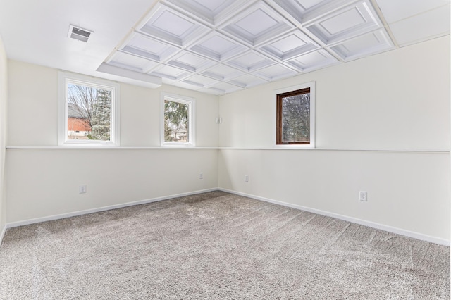 unfurnished room with coffered ceiling and carpet floors