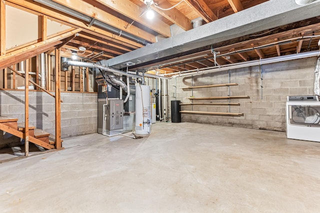 basement with heating unit, washer / clothes dryer, and gas water heater