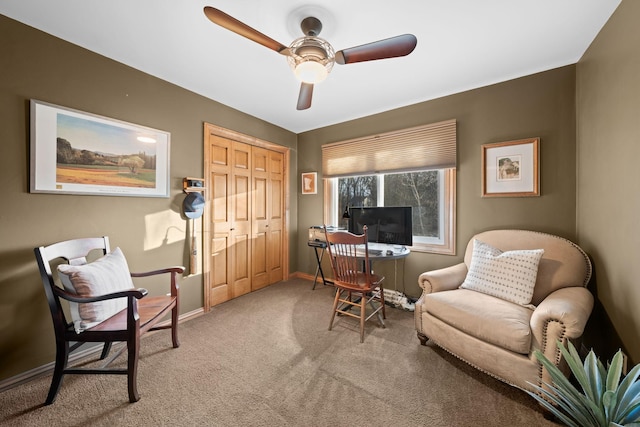 sitting room featuring ceiling fan and carpet