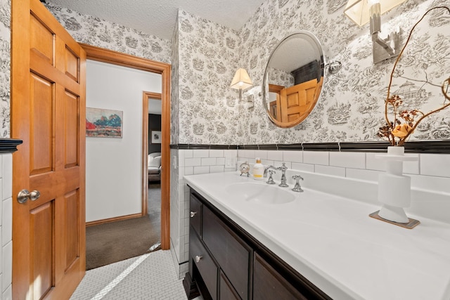 bathroom with a textured ceiling and vanity