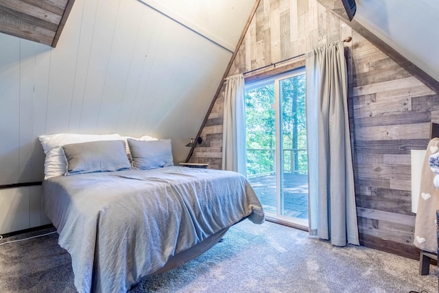 bedroom featuring carpet, access to exterior, vaulted ceiling, and wood walls